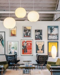 A room featuring vintage movie posters on the walls and modern pendant lighting fixtures.