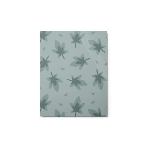Glossy metal print with repeating green leaf pattern on a muted sage background