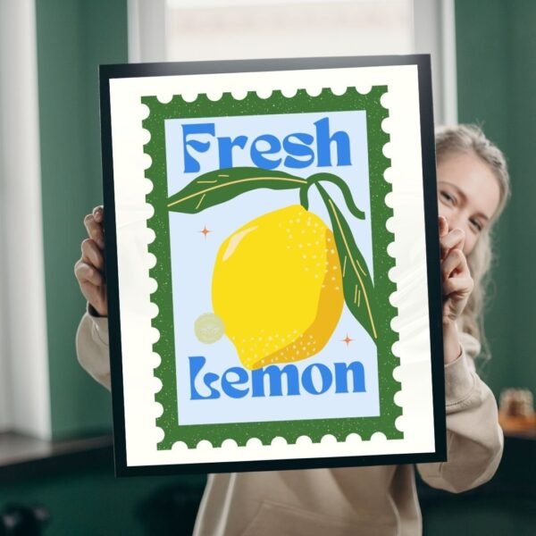 A person holding a framed Fresh Lemon poster showcases a large illustrated lemon with bold text, resembling a stamp. It features decorative elements and a green border.