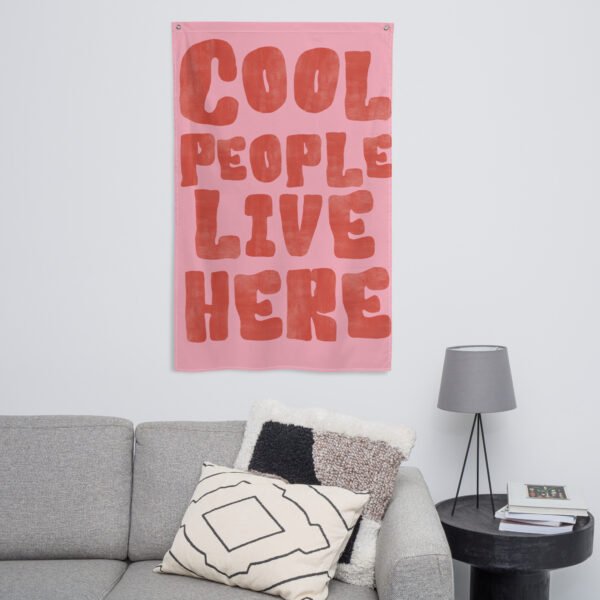 Wall hanging featuring the text 'Cool People Live Here' in bold red letters on a pink background.