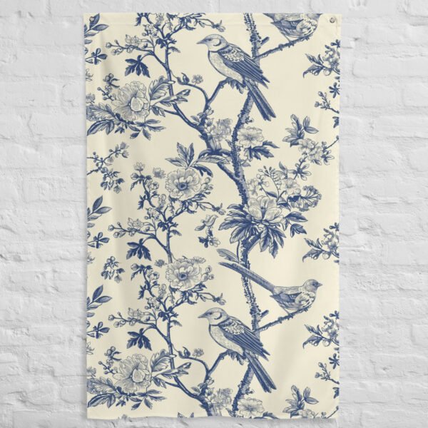 tapestry wall hanging featuring a blue floral design with birds perched on branches against a cream background.
