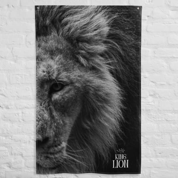 Black and white Lion face tapestry featuring a close-up of a lions intense gaze and mane, with KING LION text and a crown graphic in the lower right corner, displayed on a white brick wall.