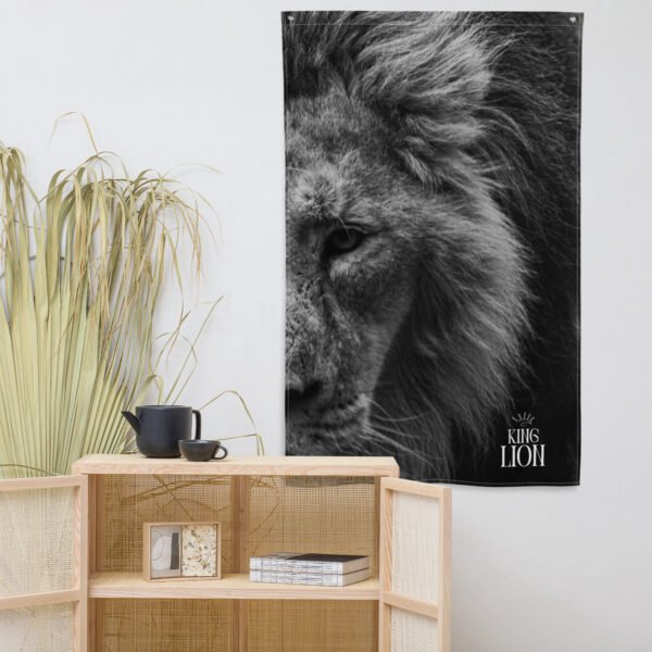 The Lion face tapestry, a black and white close-up of a lion with “King Lion” text, hangs on a white wall above a light wooden shelf holding a teapot, cup, plant, and decor items.