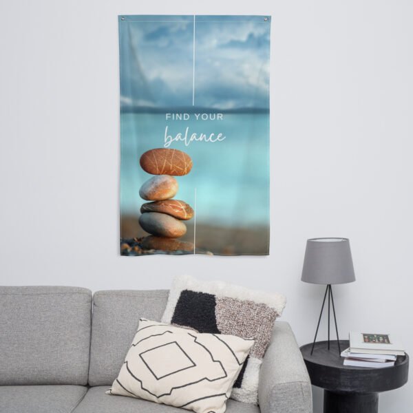 Find your balance tapestry featuring stacked stones and text on a blurred blue background.