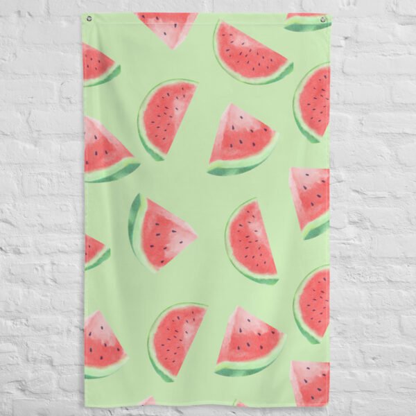 The Watermelon pattern tapestry, in light green with watercolor-style watermelon slices featuring red flesh, black seeds, and green rinds, is displayed hanging on a white brick wall.