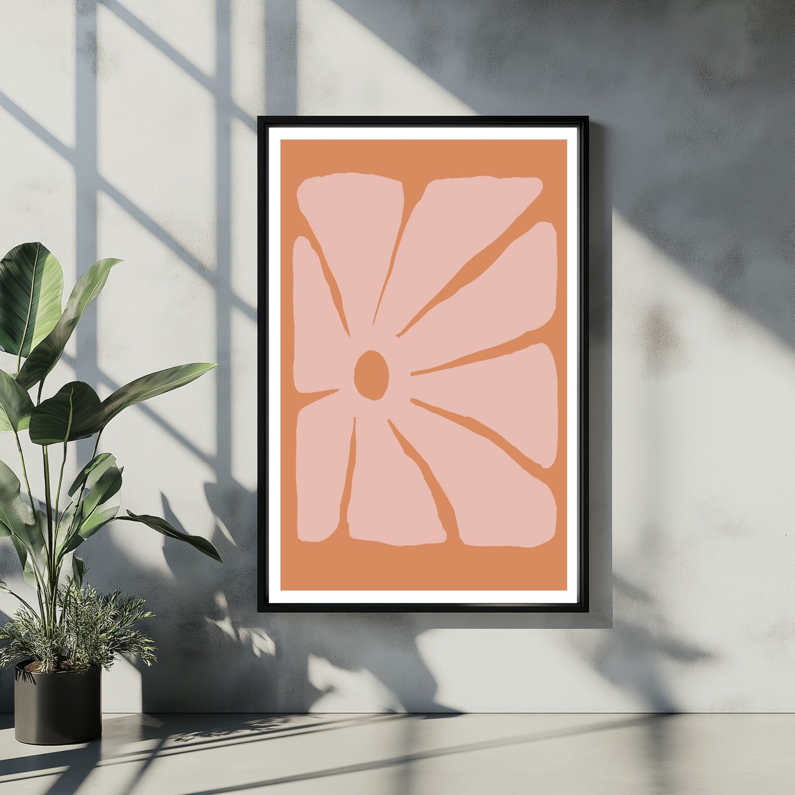 Framed abstract artwork featuring a flower design in pink and orange colors.