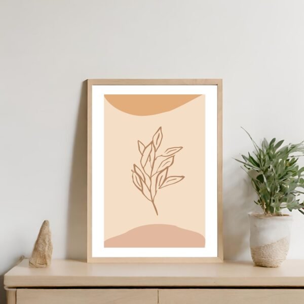 Framed line art print depicting a leaf design on a beige background.