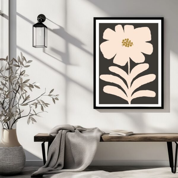 Framed artwork featuring a pink flower and leaves on a dark background.