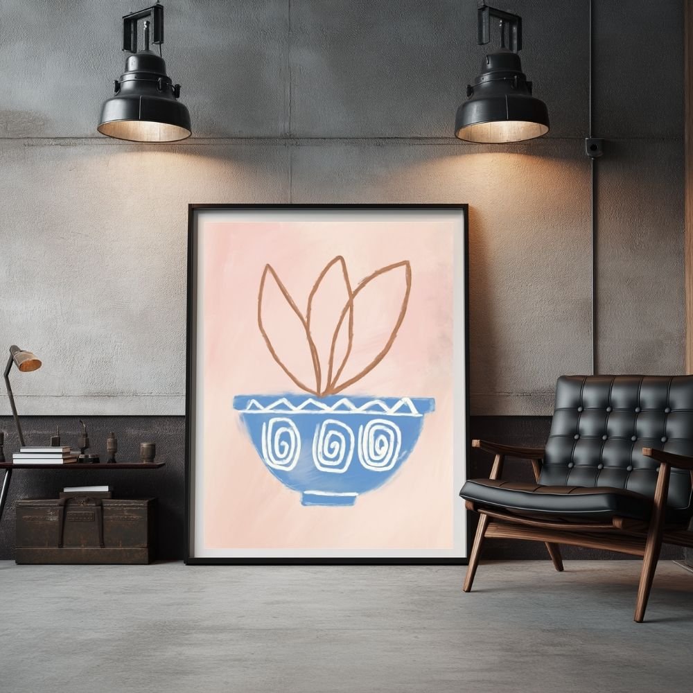 Framed abstract artwork featuring a blue bowl with leaves on a pink background.