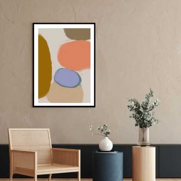 Abstract art print featuring colorful shapes in various tones, framed and displayed on a wall.