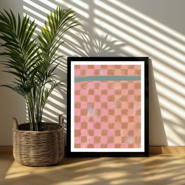 Framed abstract artwork featuring a pink and blue checkerboard pattern displayed next to a potted plant.