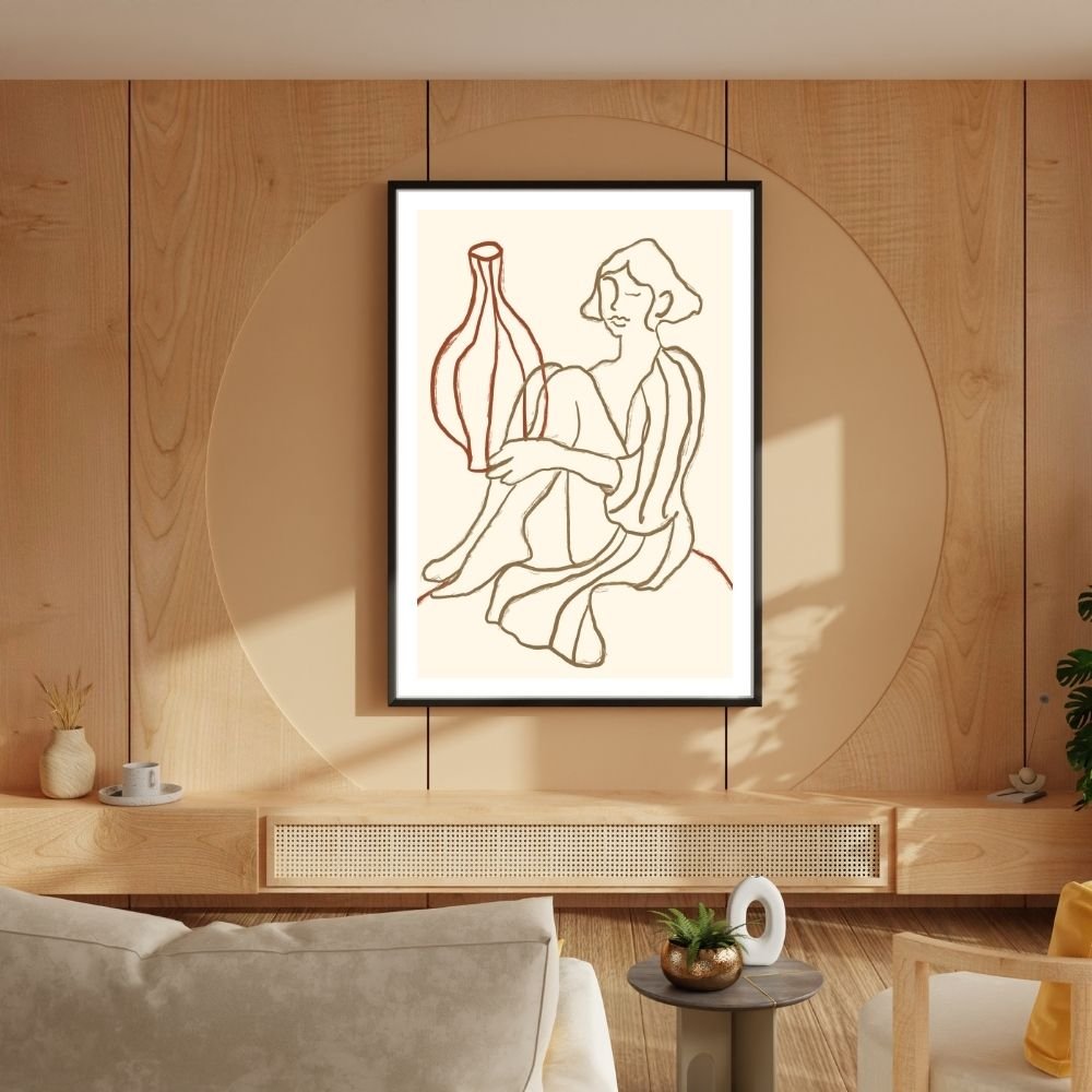 Line art illustration of a woman sitting and holding a vase, framed and displayed on a wall.