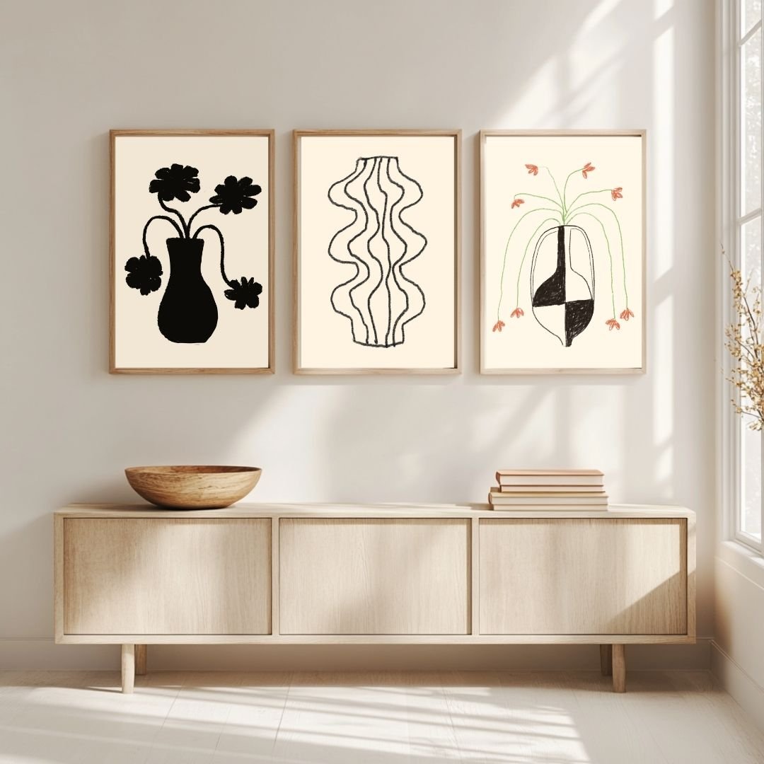 Set of three black and white art prints featuring vases with flowers and abstract designs.