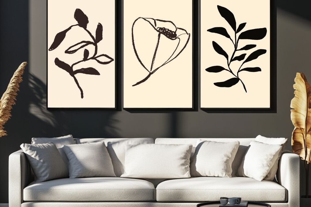 Set of three framed botanical art prints with leaves and flowers on a light background.