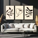 Set of three framed botanical art prints with leaves and flowers on a light background.