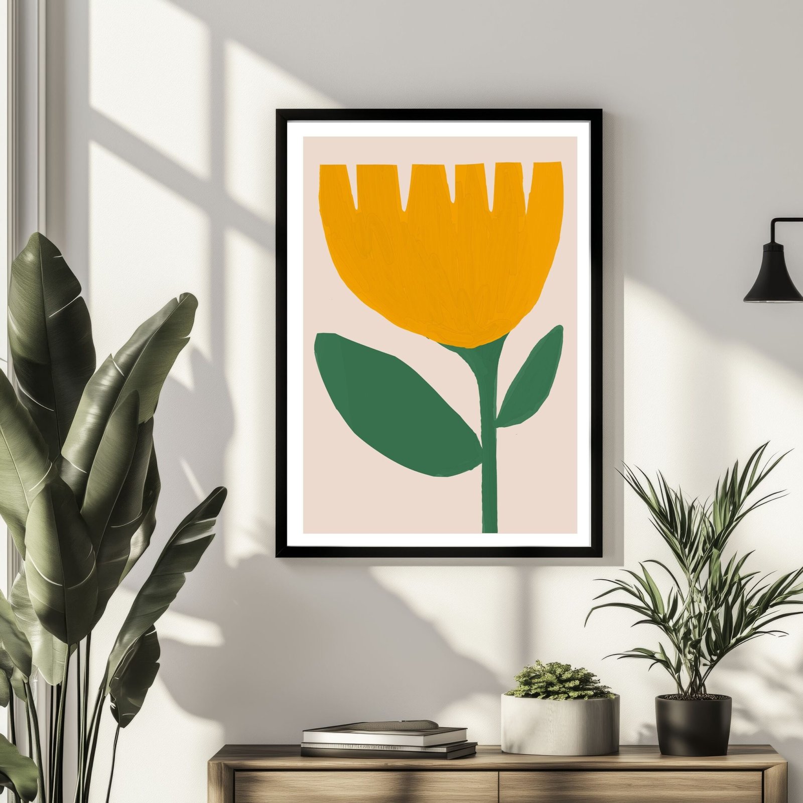 Framed artwork featuring a yellow flower with green leaves against a light background.