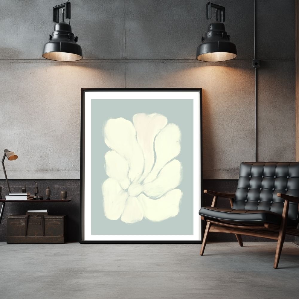 Framed artwork featuring a light-colored flower design on a muted background.