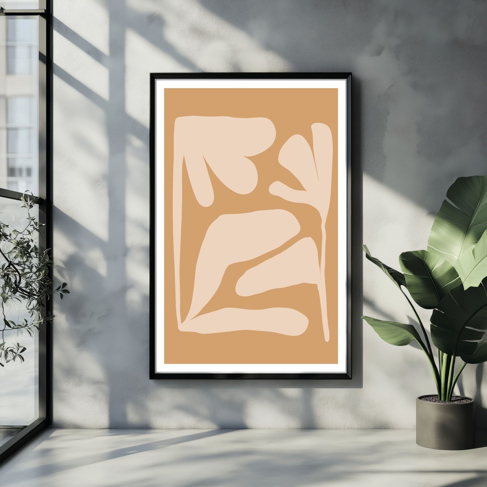 Abstract wall art featuring tan and beige shapes in a framed display.