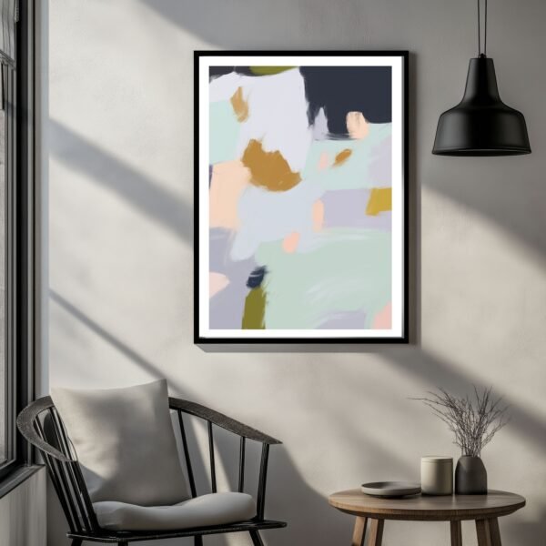 Framed abstract artwork featuring soft colors and brush strokes displayed in a room.