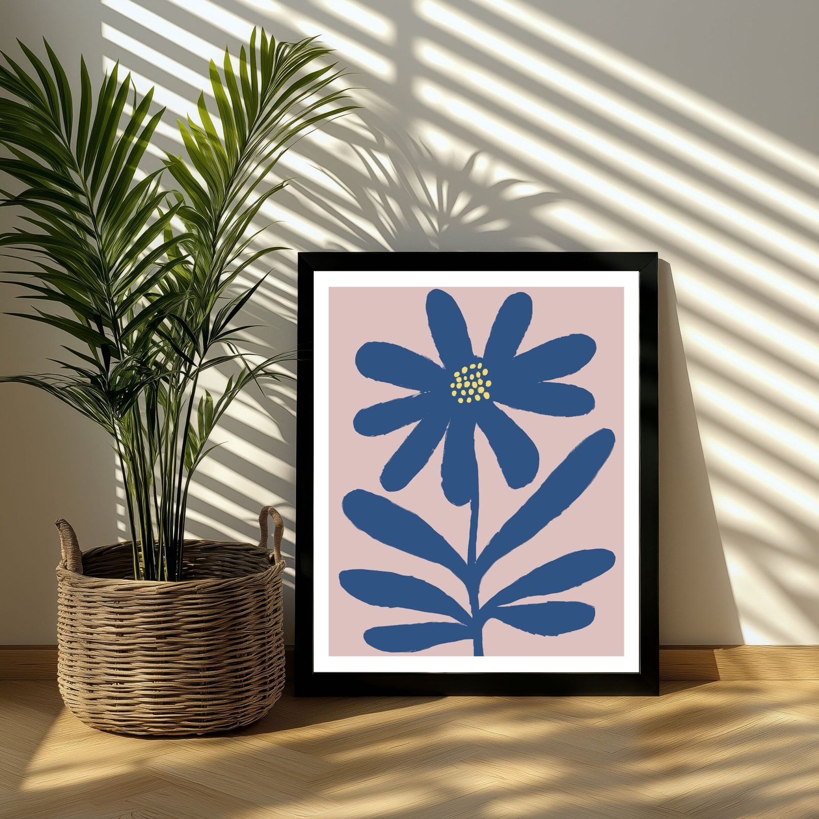 Framed artwork featuring a blue flower design on a light pink background.