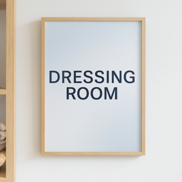 Minimalist typography poster with the words Dressing Room in black text inside a wooden frame.